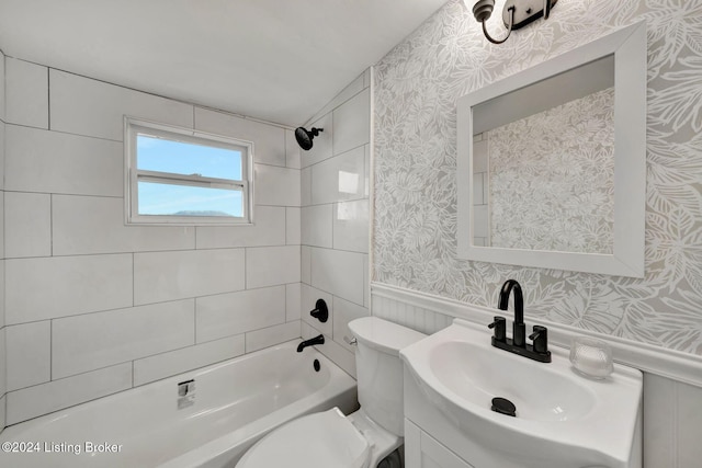 bathroom with wallpapered walls, wainscoting, vanity, shower / washtub combination, and toilet