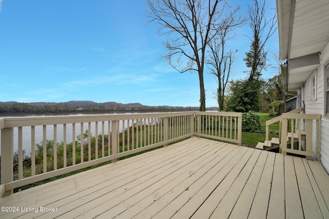 wooden deck featuring a water and mountain view