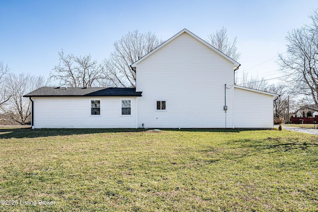 view of side of property with a yard