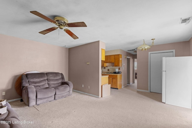 living room with light colored carpet, ceiling fan, baseboards, and visible vents
