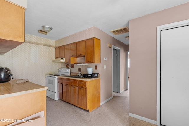 kitchen featuring white electric range oven, visible vents, under cabinet range hood, light countertops, and baseboards