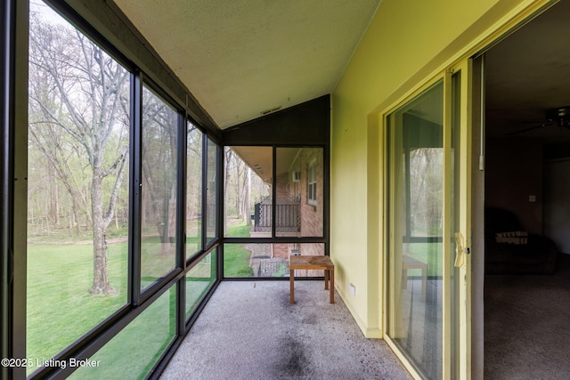 unfurnished sunroom featuring a ceiling fan