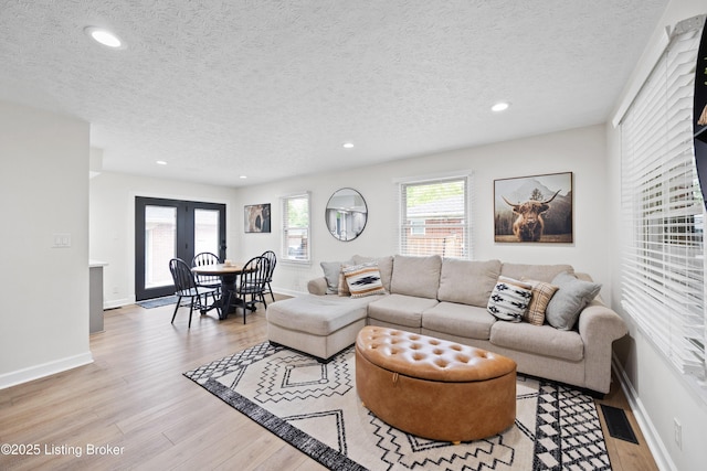 6507 S Dr, Louisville, KY 40272 - living room featuring light wood-type flooring, a textured ceiling, recessed lighting, baseboards, and french doors