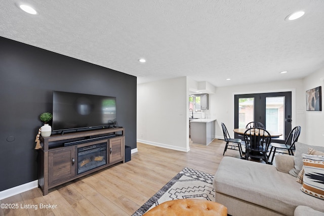 6507 S Dr, Louisville, KY 40272 - living area with a textured ceiling, recessed lighting, baseboards, light wood-style flooring, and french doors