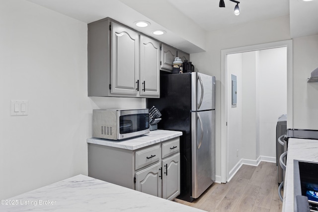 6507 S Dr, Louisville, KY 40272 - kitchen with appliances with stainless steel finishes, light countertops, light wood-style flooring, baseboards, and gray cabinetry