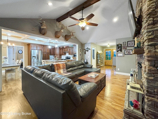 444 Wire Ln, Bardstown, KY 40004 - living room featuring vaulted ceiling with beams, a ceiling fan, a stone fireplace, and light wood-style flooring