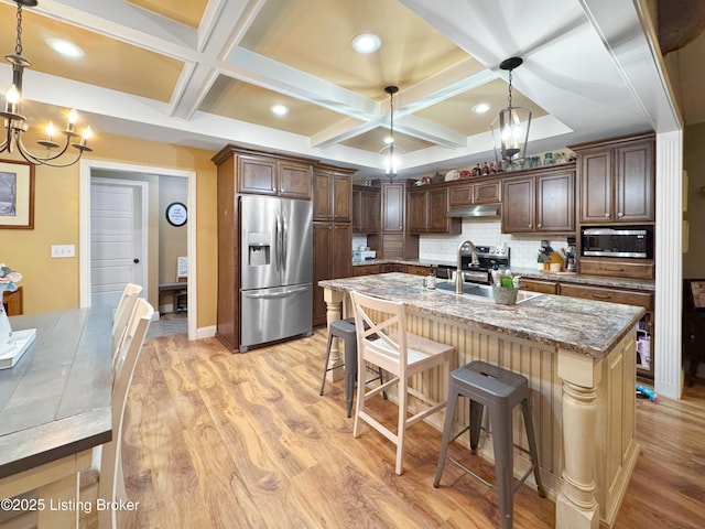 444 Wire Ln, Bardstown, KY 40004 - kitchen with under cabinet range hood, an inviting chandelier, stainless steel appliances, coffered ceiling, and light wood-style floors