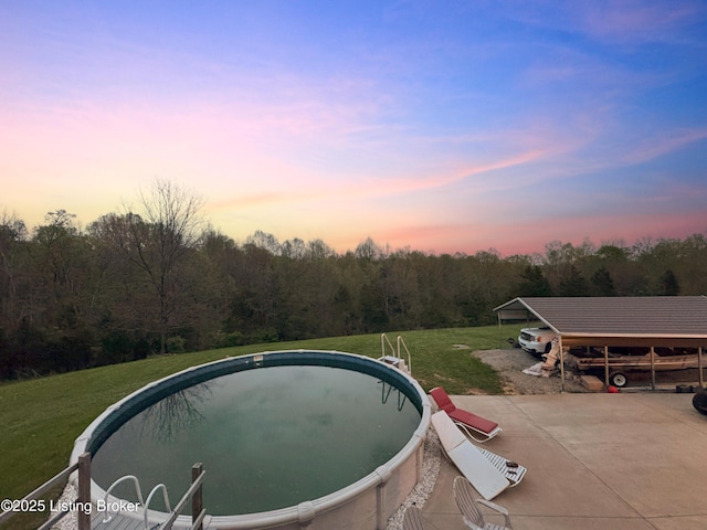 444 Wire Ln, Bardstown, KY 40004 - pool at dusk with an outdoor pool, a yard, and a wooded view
