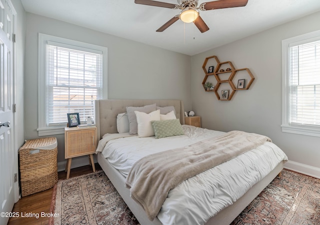 bedroom featuring baseboards, a ceiling fan, and wood finished floors