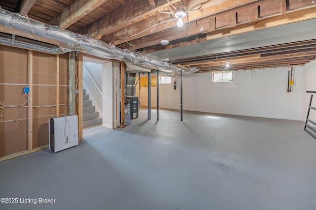 below grade area with stairway and heating unit