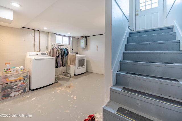 basement featuring stairway, washing machine and dryer, and electric panel