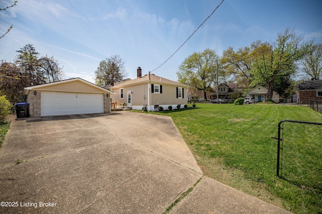 view of front of house with an outbuilding, a front lawn, fence, and a garage