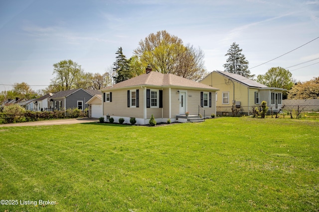 back of house with a yard, fence, driveway, and a chimney