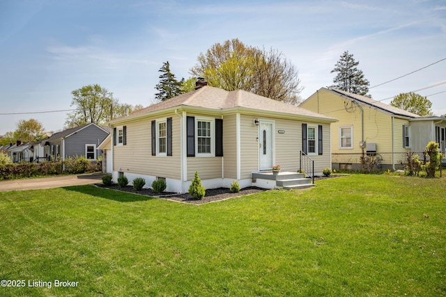 bungalow-style home with a front yard, fence, a shingled roof, and a chimney