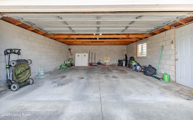 garage with concrete block wall