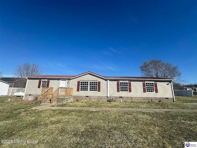 manufactured / mobile home featuring a front yard, crawl space, and fence
