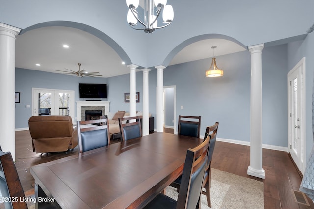 178 Bluffs Edge Dr, Mt Washington, KY 40047 - dining space with a fireplace, visible vents, ornate columns, ceiling fan with notable chandelier, and wood finished floors
