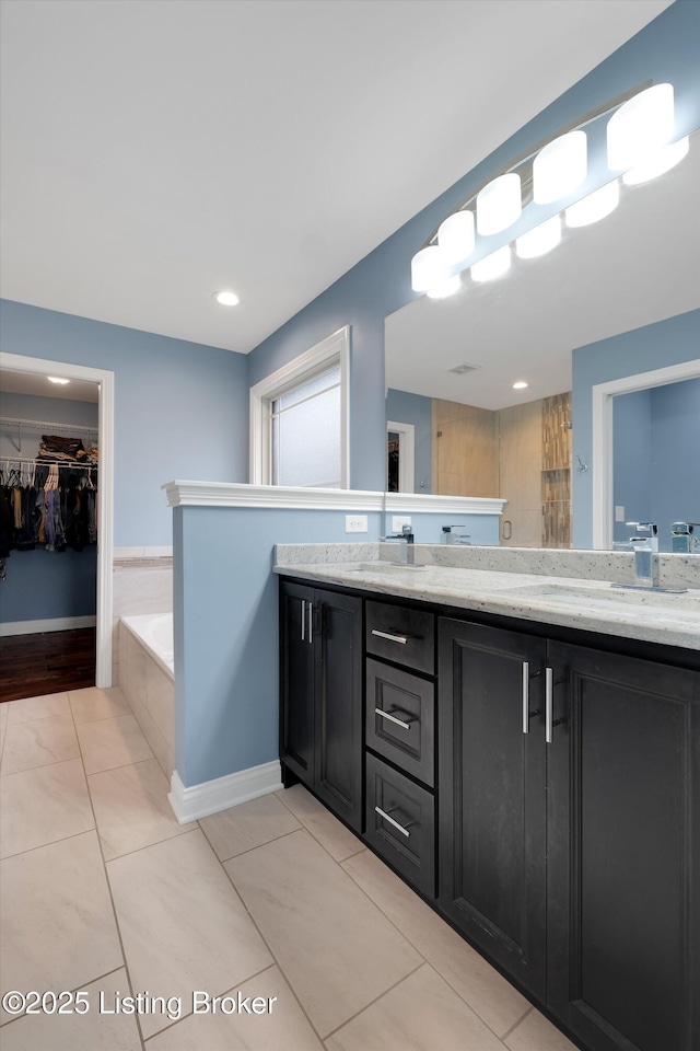 178 Bluffs Edge Dr, Mt Washington, KY 40047 - bathroom featuring double vanity, a garden tub, and a sink