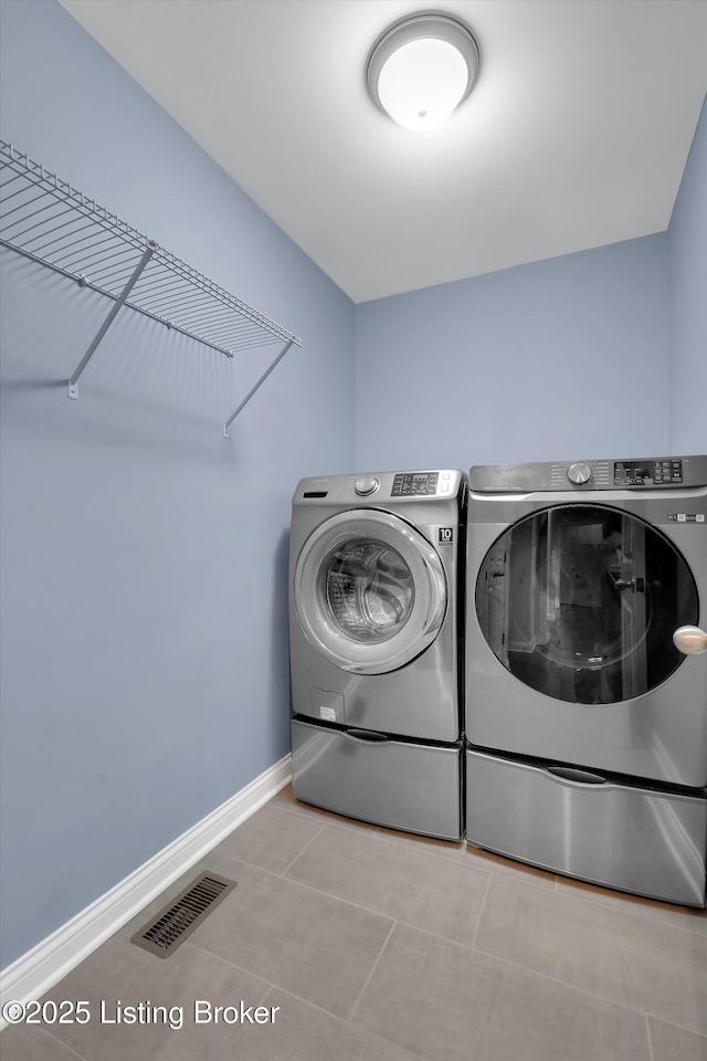 178 Bluffs Edge Dr, Mt Washington, KY 40047 - washroom with visible vents, baseboards, tile patterned floors, laundry area, and washing machine and clothes dryer