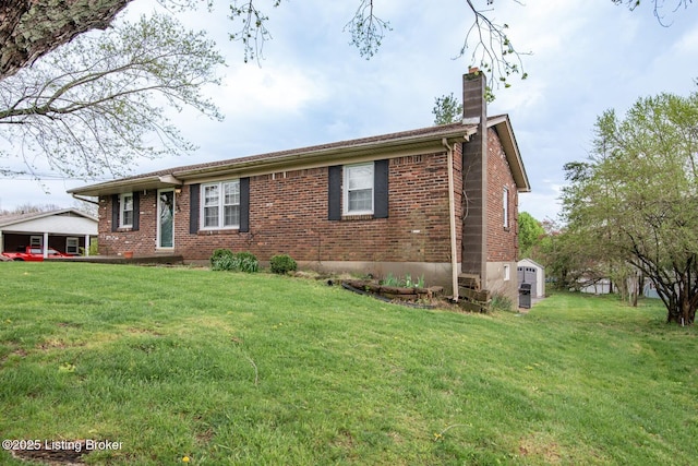 ranch-style home with brick siding, a front lawn, and a chimney