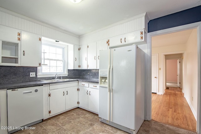 kitchen featuring white appliances, crown molding, and backsplash