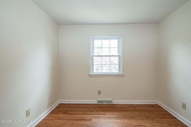 unfurnished room with visible vents, baseboards, and light wood-type flooring