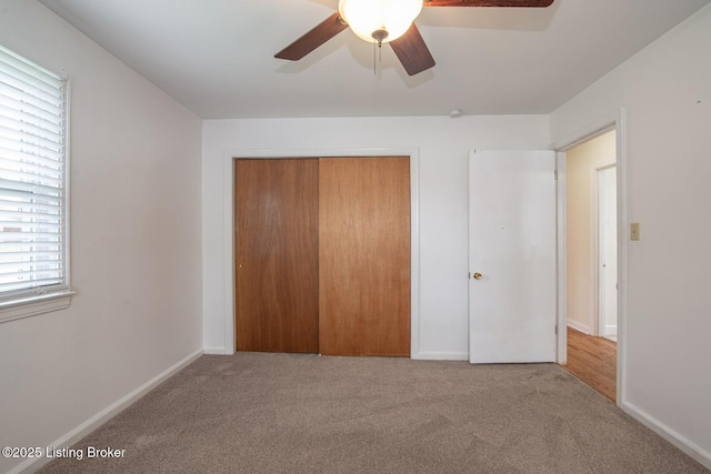 unfurnished bedroom with a closet, baseboards, and carpet