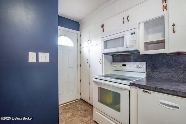 kitchen with white cabinetry, decorative backsplash, dark countertops, and white appliances