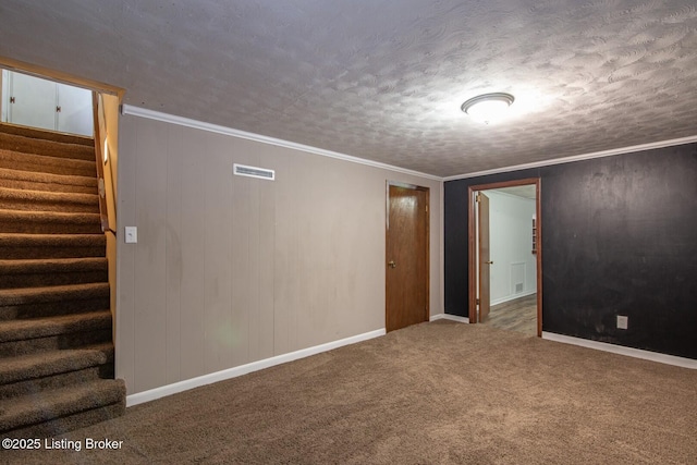 spare room featuring carpet, a textured ceiling, visible vents, stairway, and baseboards