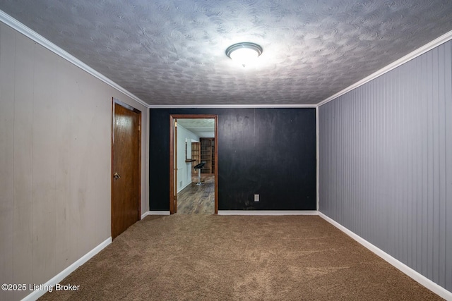 spare room featuring a textured ceiling, baseboards, and carpet floors