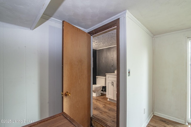 hall featuring crown molding and wood finished floors