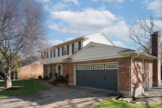 view of front of property with a chimney, driveway, a front yard, brick siding, and a garage