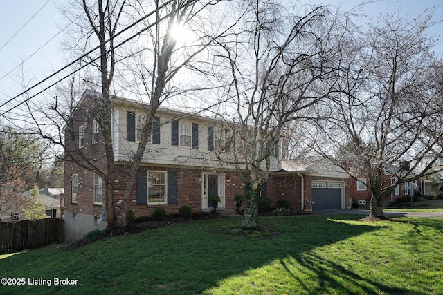 view of front of property featuring an attached garage, fence, a front lawn, and brick siding
