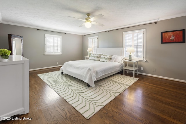 bedroom with a textured ceiling, wood finished floors, baseboards, and ornamental molding