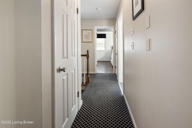 hall featuring baseboards