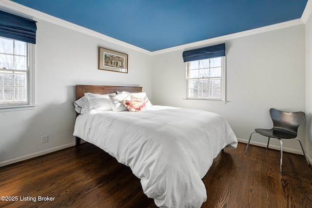 bedroom with crown molding, wood finished floors, and baseboards