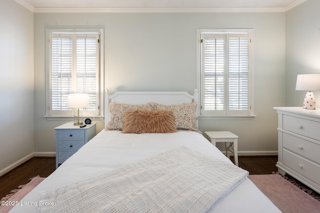 bedroom with crown molding, baseboards, and dark wood finished floors