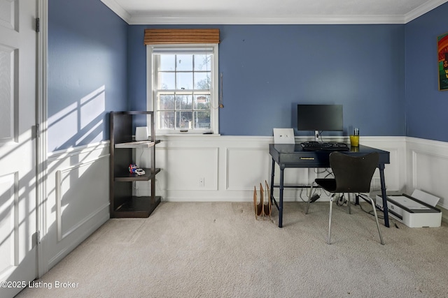 carpeted office featuring crown molding, a decorative wall, and wainscoting