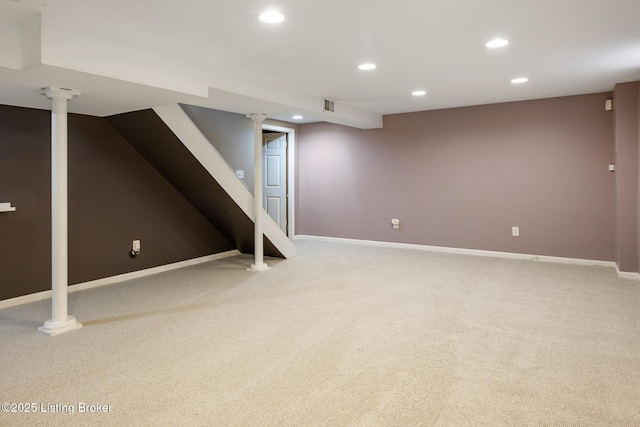 finished below grade area with light colored carpet, visible vents, stairway, recessed lighting, and baseboards