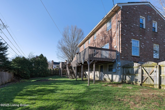 view of yard featuring stairs, a fenced backyard, and a wooden deck