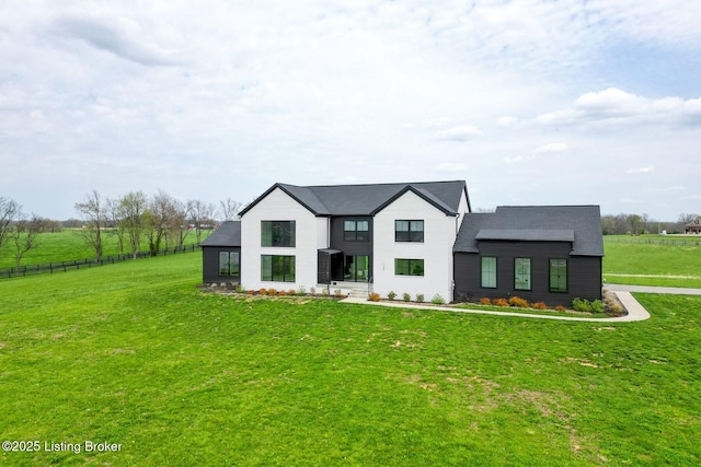 modern farmhouse style home with fence and a front yard