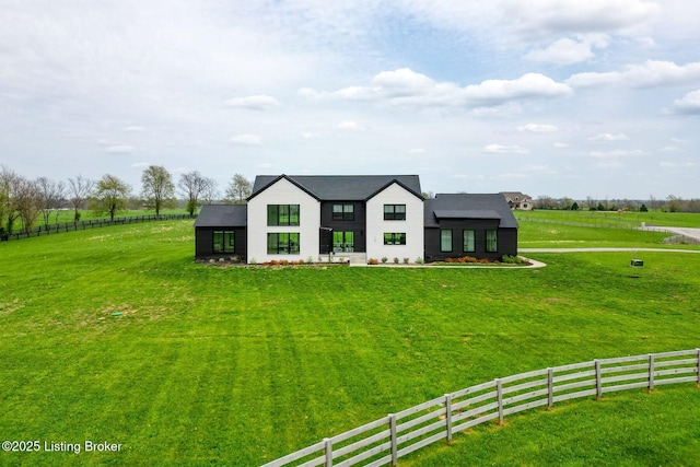 view of front of house with a front yard and fence