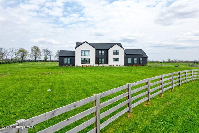 modern farmhouse featuring fence and a front yard