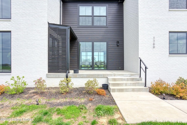 property entrance with brick siding