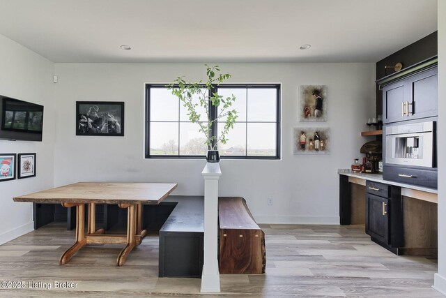 dining area with baseboards, light wood-style floors, and recessed lighting