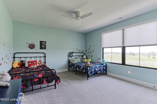 carpeted bedroom with baseboards, visible vents, and ceiling fan