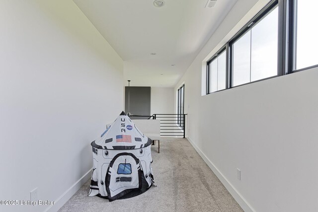 rec room featuring baseboards, carpet flooring, and visible vents