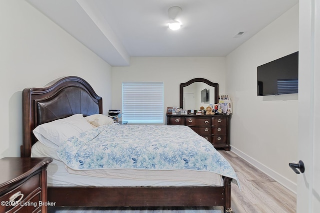bedroom featuring visible vents, light wood finished floors, and baseboards