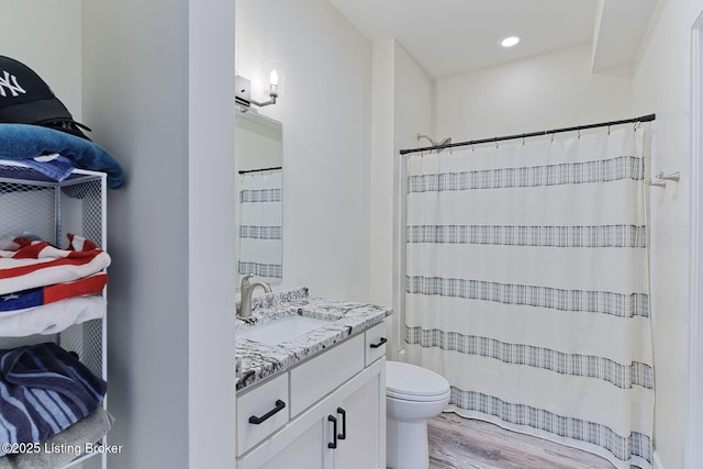 bathroom featuring toilet, a shower with curtain, vanity, and wood finished floors