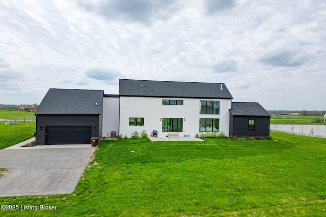 view of front of house featuring fence, a front lawn, central AC unit, and concrete driveway